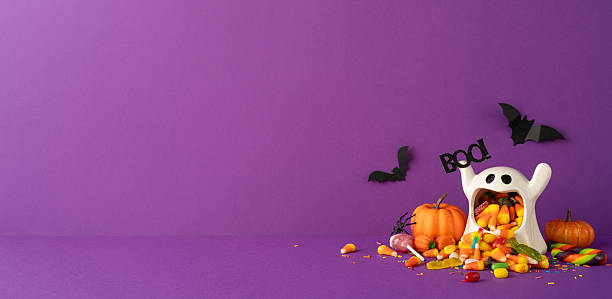 istock Festive Halloween side view tabletop scene featuring a ghost bucket filled with colorful candy, pumpkins, and bats on purple background. Perfect for creating a spooky and celebratory Halloween design 2226536911