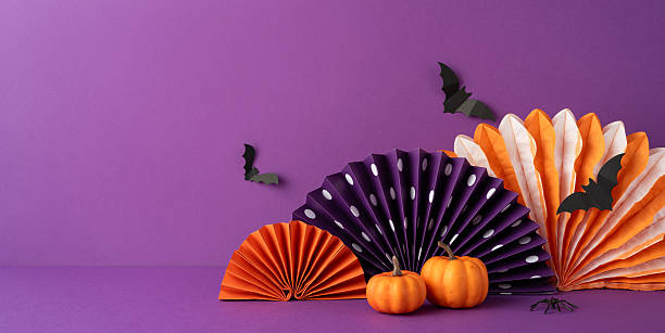istock A vibrant Halloween-themed side view arrangement featuring pumpkins, black bats, and folded paper decor on a purple backdrop, perfect for festive or seasonal designs 2226536918