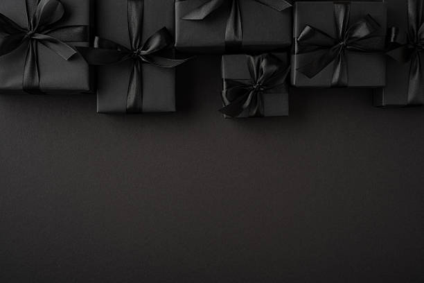 istock Dark toned composition featuring black wrapped gift boxes with bows, ideal for sale promotions 2226536935