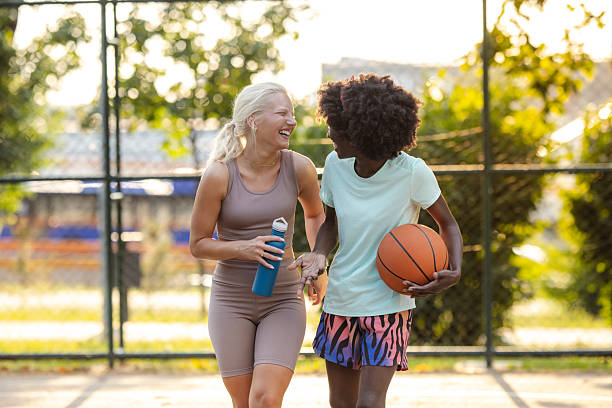 istock Two friends enjoy basketball outdoors in a sunny park setting 2226537557