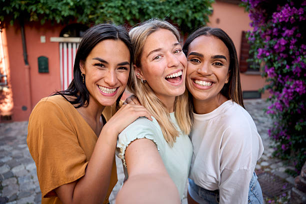 istock Three happy multi-ethnic friends taking a selfie on vacation in italy 2226541075