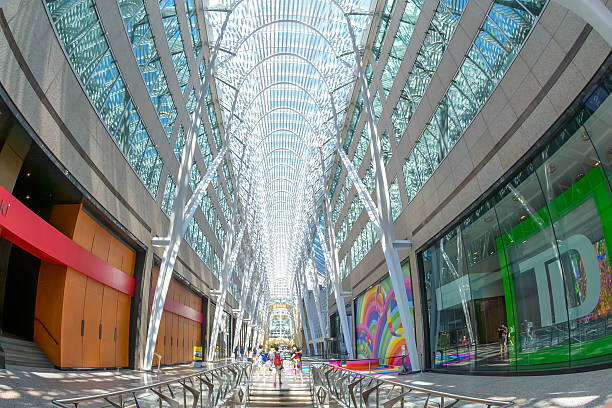 Toronto, Canada - July 13, 2025: Interior view of the Allen Lambert Galleria, showcasing its soaring glass atrium, modern steel arches, and colorful storefronts.