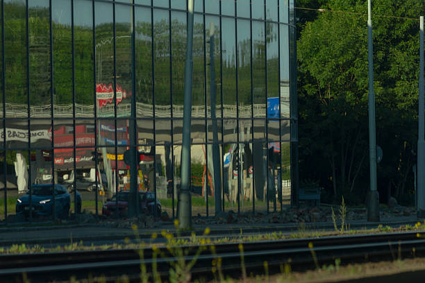 istock A train travels down tracks in front of a windowed building 2226545734