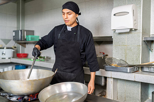 istock Peruvian chef preparing seafood in a wok in a restaurant kitchen 2226551698