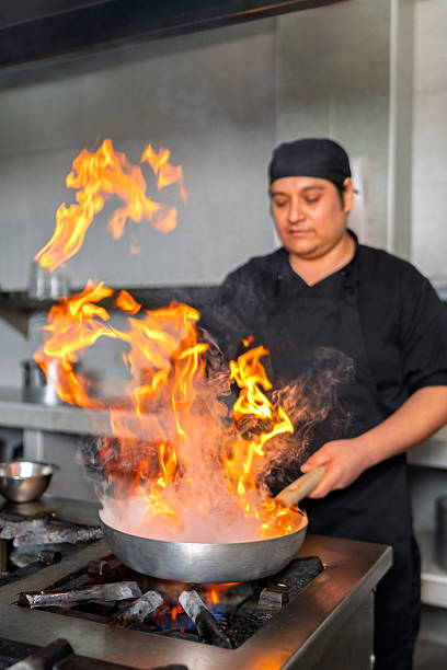 istock Peruvian chef preparing fish with flames in a wok in a restaurant kitchen 2226551730