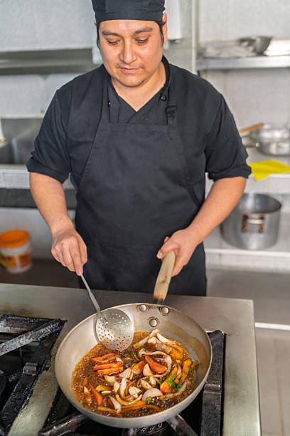 Man is serving the nursing home restaurant's buffet lunch