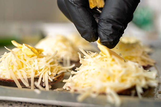istock Chef adding butter to parmesan shells au gratin 2226553429