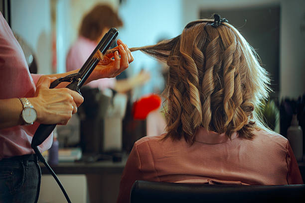 istock Hairdresser Creates Curls with the Hair Curler 2226554607