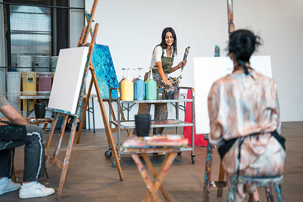 istock Middle Eastern Art Teacher Guiding Young Adults in a Bright Creative Studio 2226555617