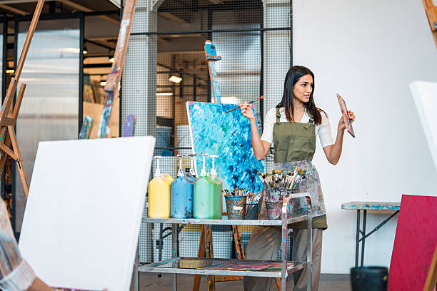 istock Young Middle Eastern Art Teacher Demonstrating Techniques With Paint Supplies In Modern Studio 2226555652