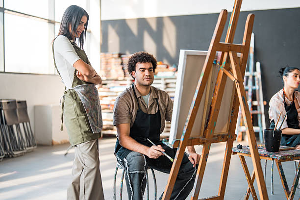 istock Young Middle Eastern Art Student Receiving Painting Instruction In Sunlit Studio Workshop 2226555673