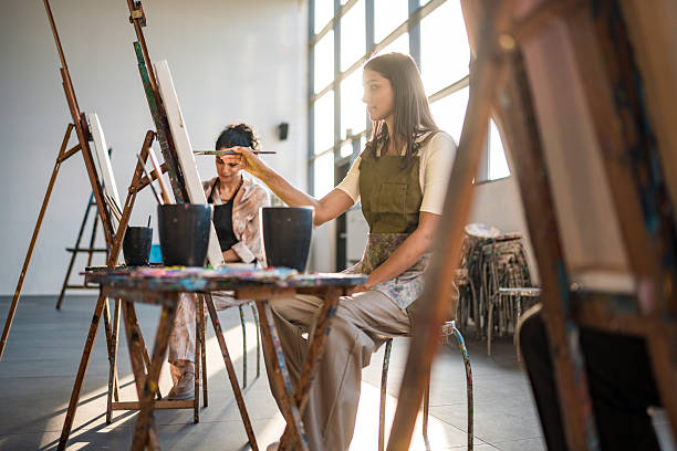 istock Young Women In Art Studio Working On Canvas Paintings During Creative Workshop 2226555726