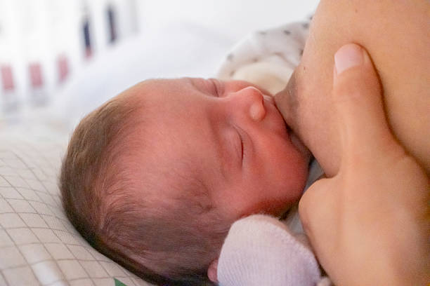 istock Mother feeding her baby milk 2226557114