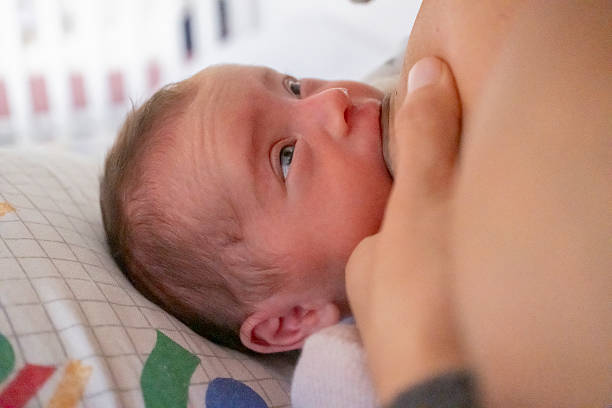 istock Mother feeding her baby milk 2226557177