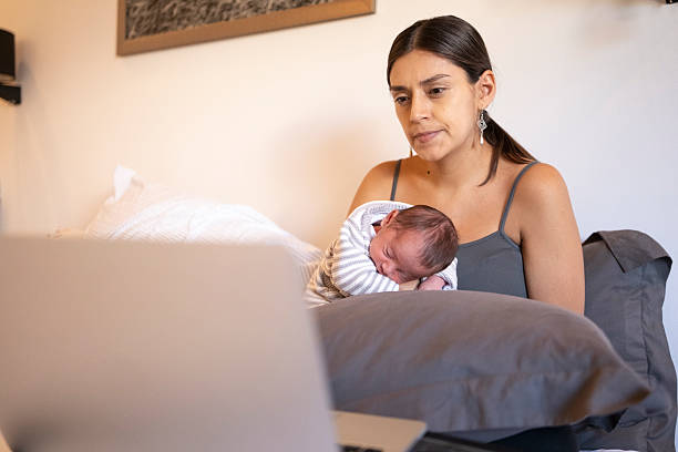 istock Mom researching while hugging her baby 2226557586