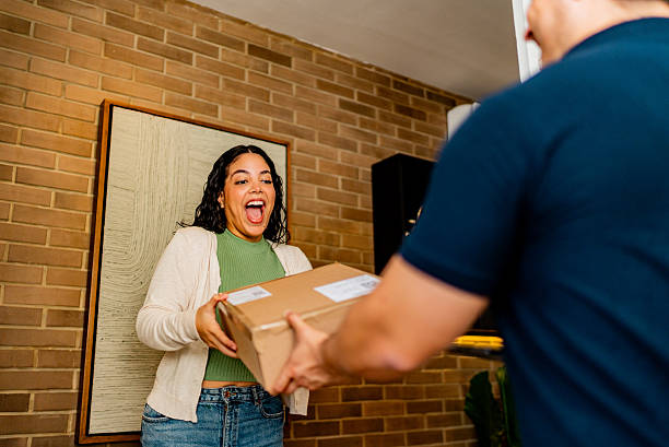 istock Young woman receiving a package at home 2226557660