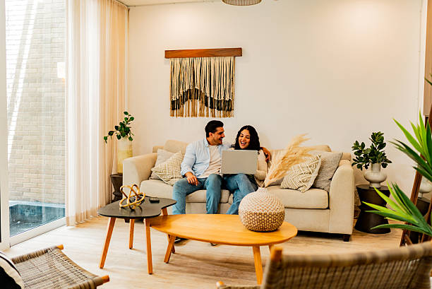 istock Couple talking and using laptop at home 2226557795