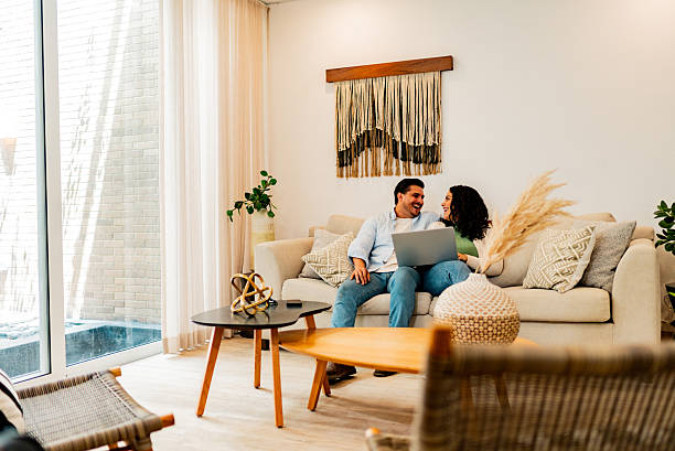 istock Couple talking and using laptop at home 2226557800