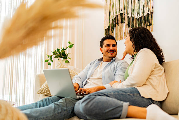istock Couple talking and using laptop at home 2226557810