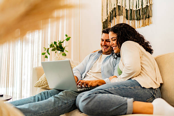 istock Couple talking and using laptop at home 2226557888