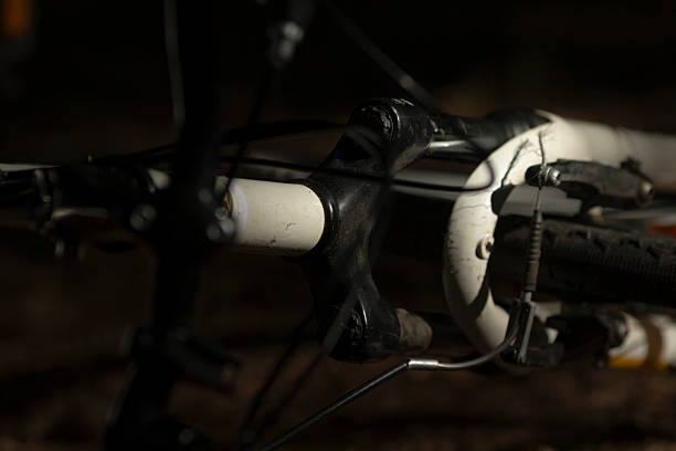 Closeup of bicycle handlebars in a dimly lit room