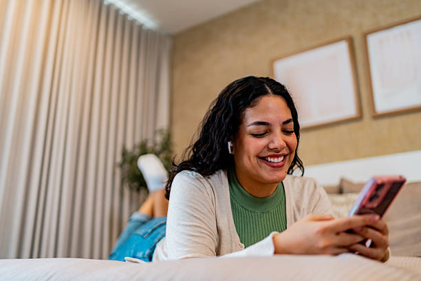 istock Young woman using mobile phone at home 2226558937