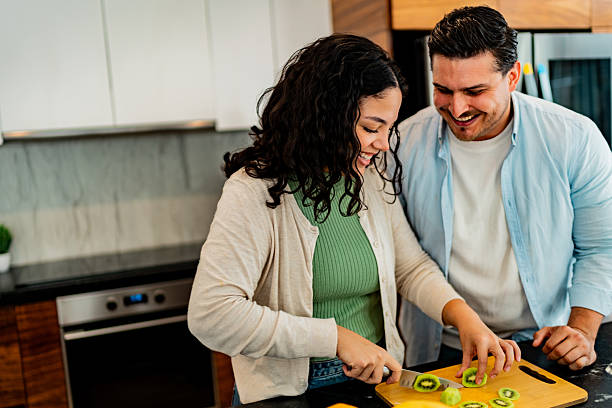 istock Couple talking and chopping kiwi at home 2226559061