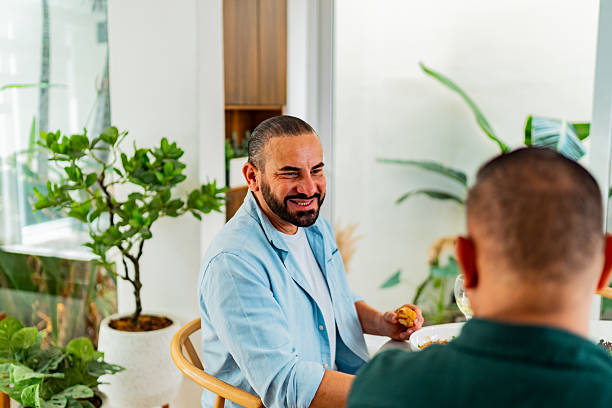 istock Gay couple talking during lunch at home 2226559860