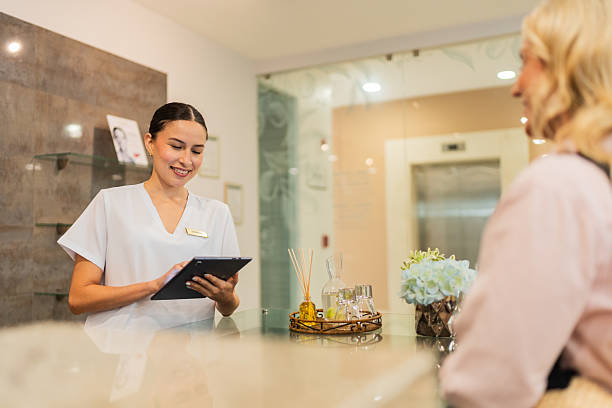 istock Young receptionist talking to customer at Spa 2226560171