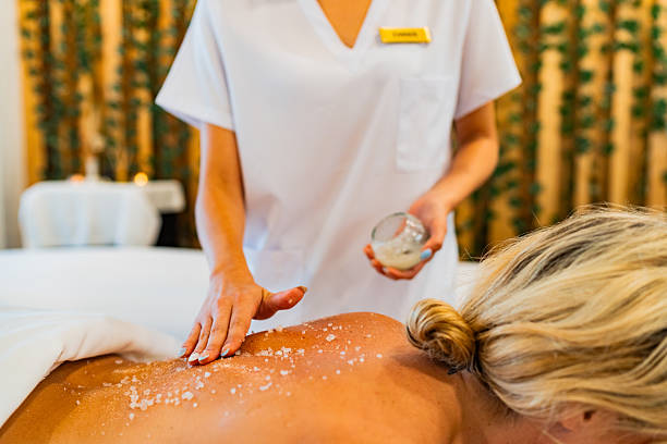 istock Masseuse applying exfoliant to customer at spa 2226560258