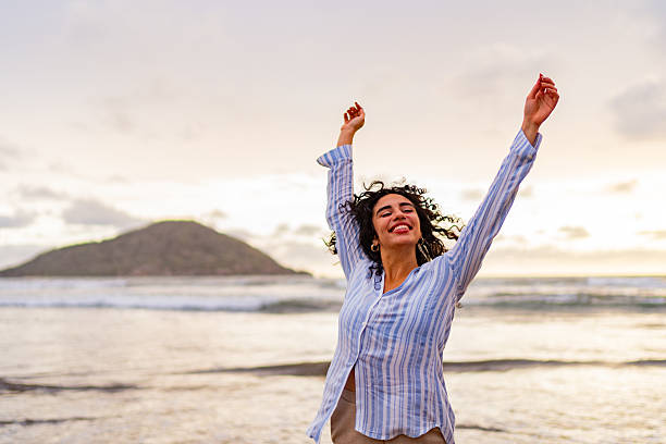 istock Happy young woman on the beach 2226560407
