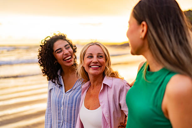 istock Friends women talking and walking on the beach 2226560456