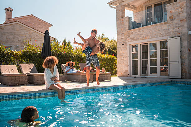 istock Father and Son Dive into Pool Fun Together 2226563758