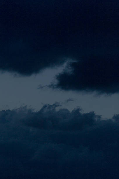 istock A dark blue sky filled with a few soft clouds drifting in it 2226570107