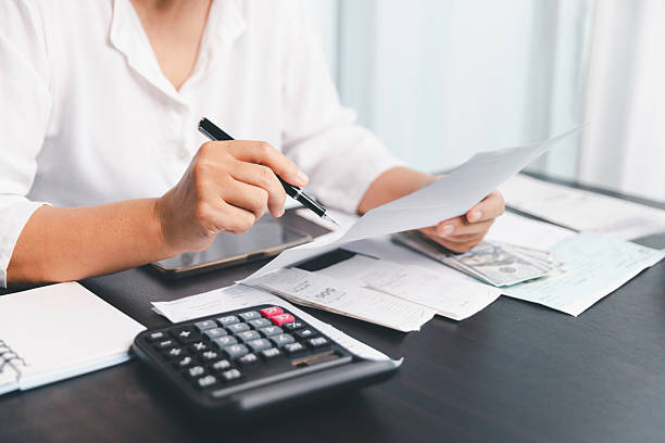 istock Using calculating machine, household carefully manages each bill and expense to plan financial budget, ensuring timely payment, consistent saving, smart investment for secure home finance strategy. 2226572554