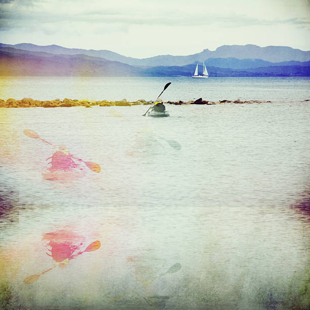 A young kayaker paddles towards the  distance with multiple and mirror versions leaving a trail behind. Digital twin concept.