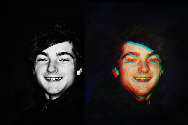 A multiple exposure image of a happy smiling teenage boy against a black background. Futuristic concept.