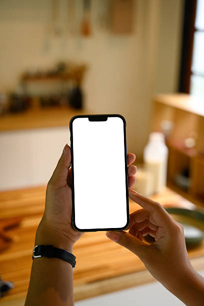 istock Hand showing mobile phone with empty display, for app or website mockup 2226579776