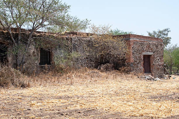 Historic stone and brick museum building surrounded by dry vegetation in Cocula, Jalisco, Mexico
