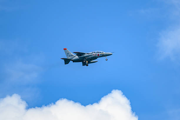 Gijon, Spain - May 24, 2024: Three airplanes fly in formation against a clear blue sky at an air show