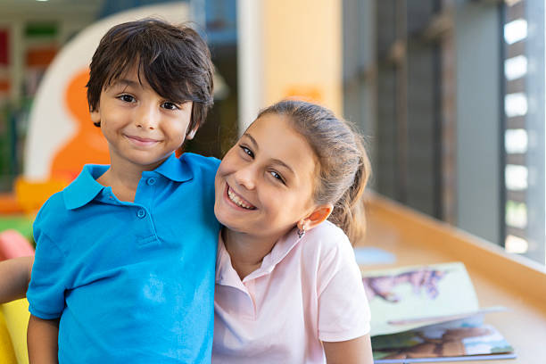 Cute little boy and girl in library