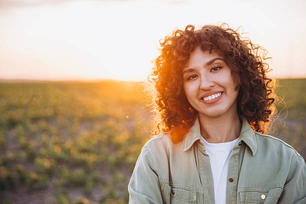 istock Young agronomist smiling in cultivated field at sunset 2226588333