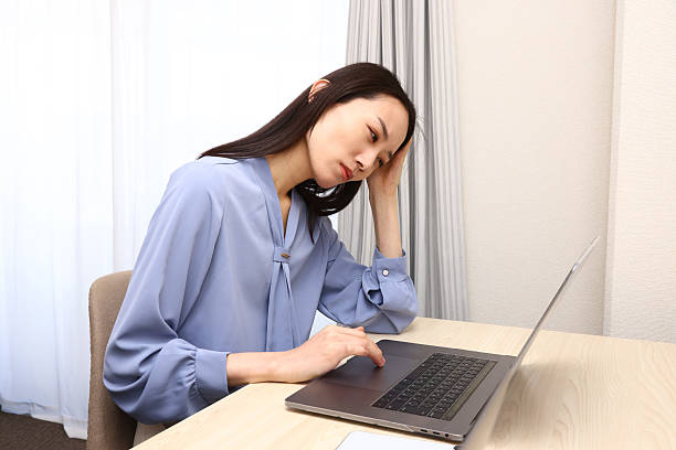 istock Female employee holding her head 2226588619