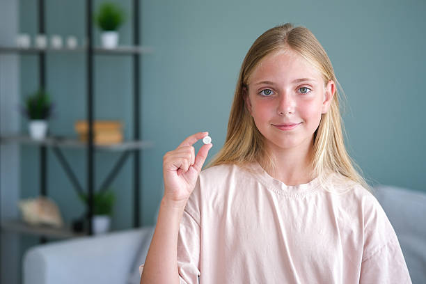 istock The child holds a pill in his hand 2226589511