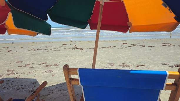 istock View Underneath Colorful Beach Umbrellas and Beach Chairs 2226590544