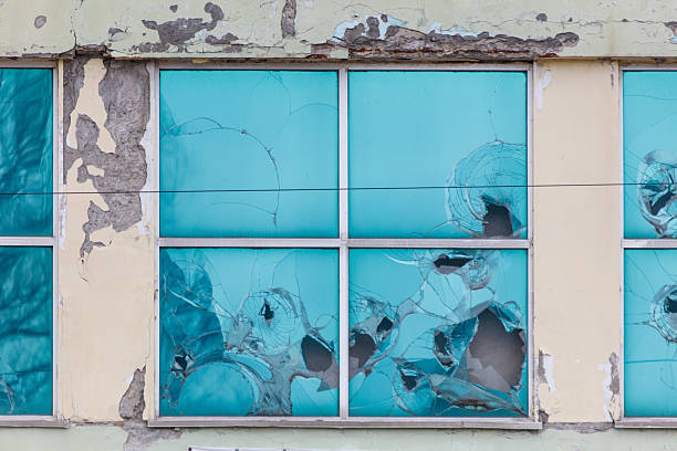 istock A window with bullet holes in it 2226590682