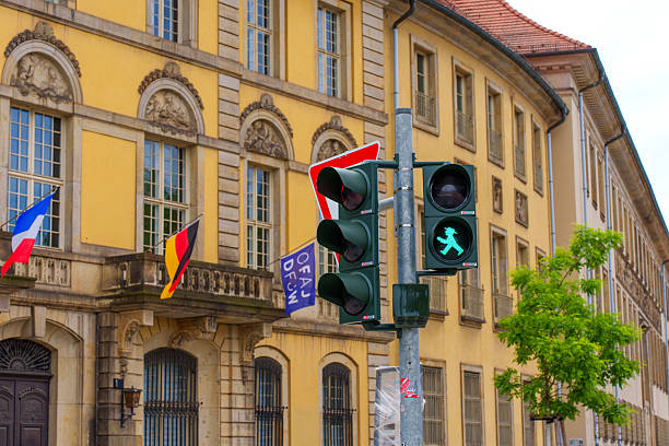Berlin, Germany - June 1, 2025: Facade of the historic Ephraim-Palais in Berlin featuring traffic lights and flags, highlighting urban architecture and vibrant city life.