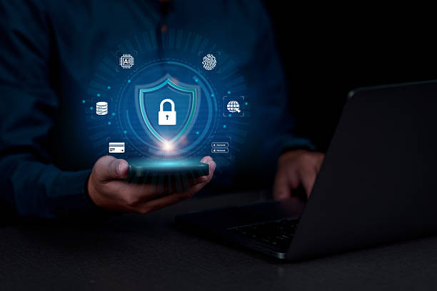 istock Data protection Cybersecurity Privacy concept. A person holds a smartphone with a glowing lock and shield icon, symbolizing cybersecurity. Represent AI, fingerprint ID, data, and online security. 2226595598