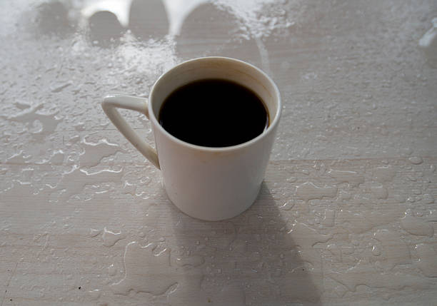Coffee cup on the table with water drops, stock photo