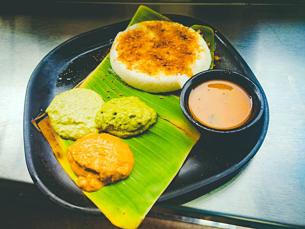 istock Idli with three chutneys and sambar served on a banana leaf in India. High-angle, close-up composition. 2226596191